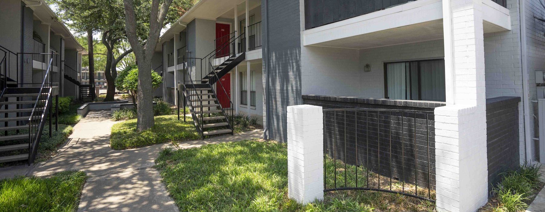 an apartment building with a path and stairs
