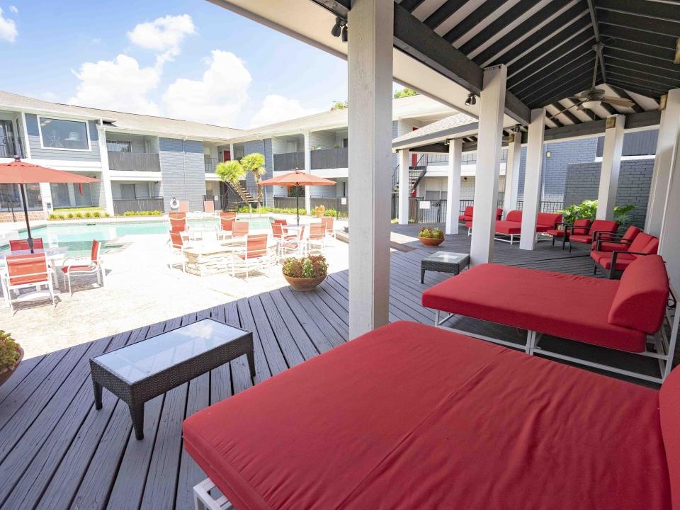 a patio with tables and chairs