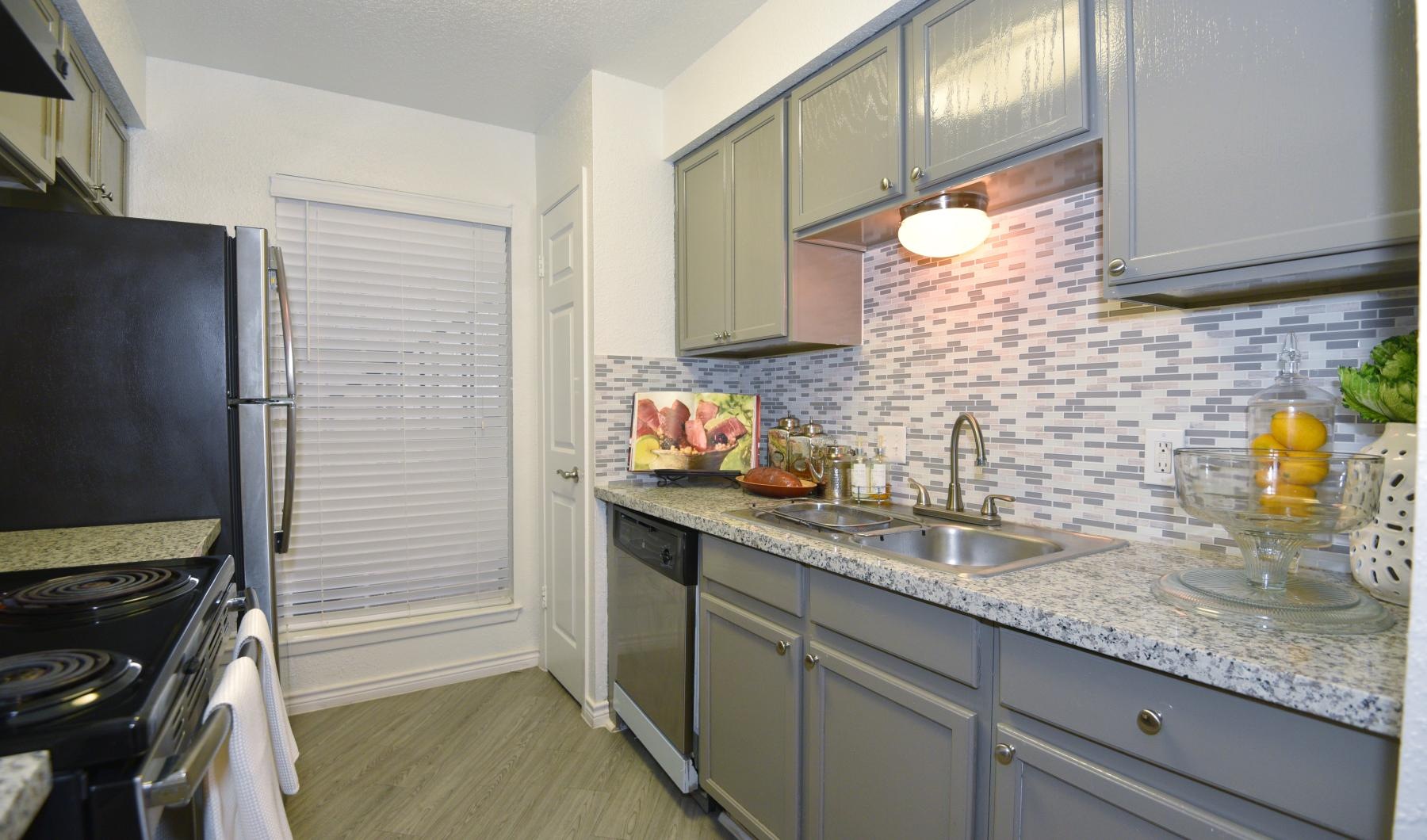 a kitchen with a stove and oven